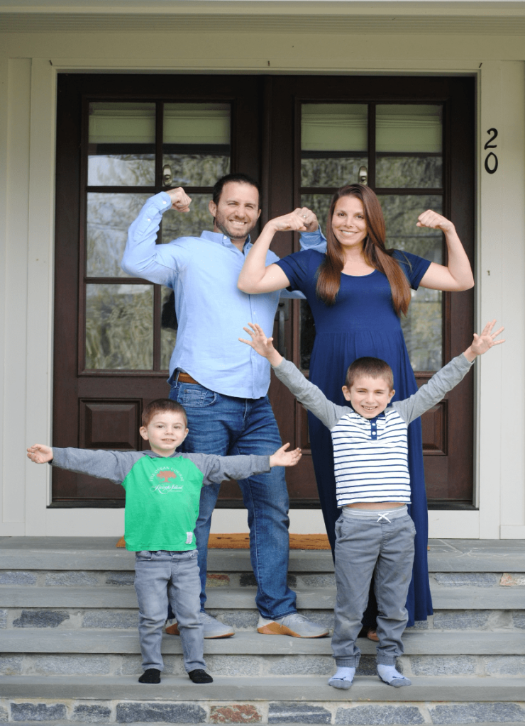 Dr. Markowitz and his family posing on the front steps of a house